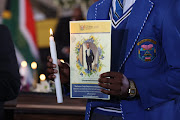 A school pupil in uniform at the mass funeral.