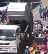 A refuse truck empties a load of rubbish on the street in Pretoria.