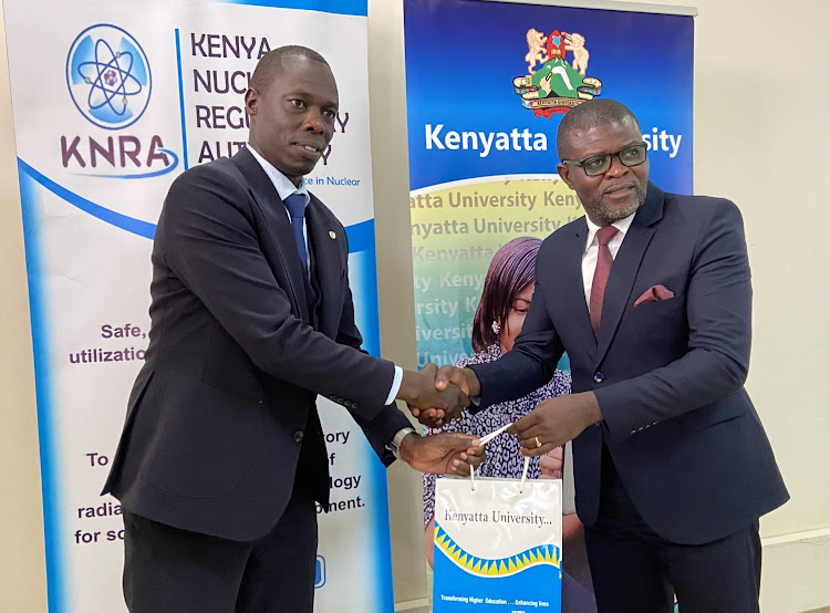 Kenya Nuclear Regulatory Authority Director General James Keter (left) with Kenya University Registrar Richard Oduor last Thursday.