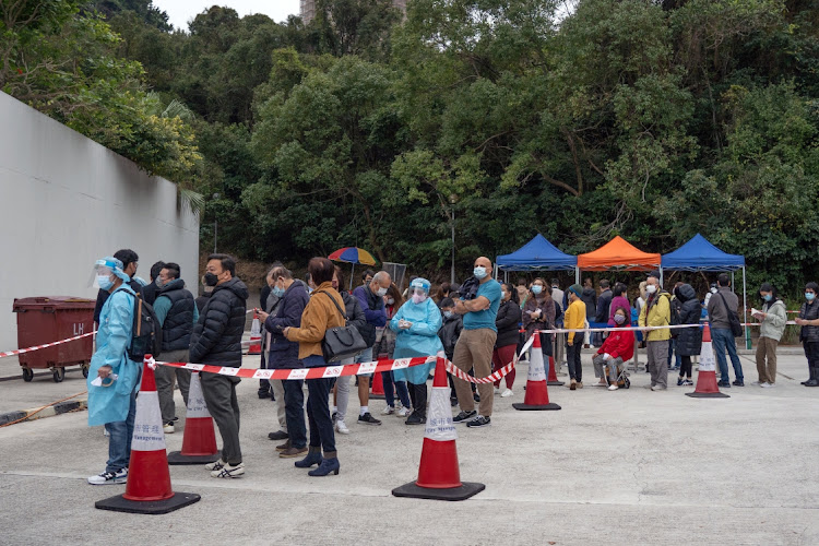 Residents wait in line at a Covid-19 testing facility in Discovery Bay on Lantau Island in Hong Kong on February 9 2022. Picture: BLOOMBERG/BERTHA WANG