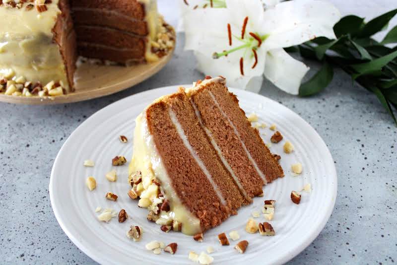 A Slice Of Chantilly Cake On A Plate.