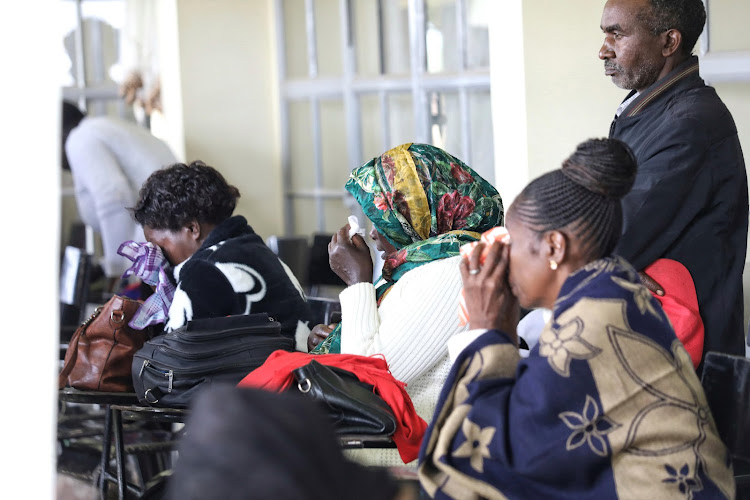 Widows and family members of fallen police officers during a memorial service at Embakasi AP training College, Nairobi on December 14, 2022.