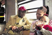 STRONG VIEWS: Cope leader Mvume Dandala and Annalien Swarts with her baby Valentino during his campaign in trains between Pretoria and Joburg. 01/04/2009. 9 Sowetan. Pic. Antonio Muchave.