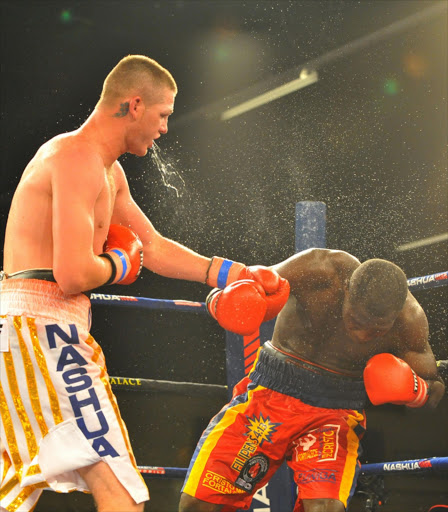 "I'm no criminal, but it could be murder," Tommy Oosthuizen, pictured here in white trunks, said of the March 21 IBO light-heavyweight title fight between the pair, which was officially launched at SuperSport in Johannesburg on 10 December 2014. Image by: Duif du Toit / Gallo Images