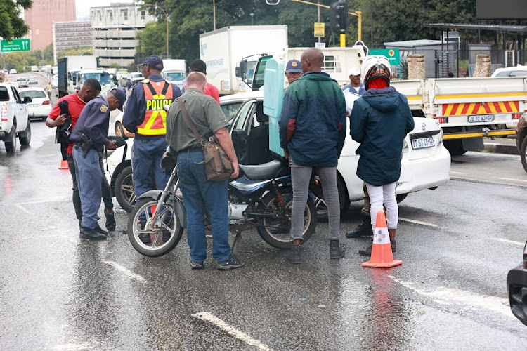 A team consisting of Gauteng police, Gauteng traffic police and the Johannesburg Metro Police Department conduct a stop and search operation of motorists' vehicles in Hillbrow, Johannesburg.
