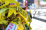 Police tape is pictured at a trash can on the street, at a crime scene after a deadly mass shooting on South Street in Philadelphia, Pennsylvania, US, June 5, 2022.  