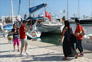 File picture shows tourists visiting the Marina in Monastir, a popular tourist destination near Sousse, 140 kilometres south of the Tunisian capital