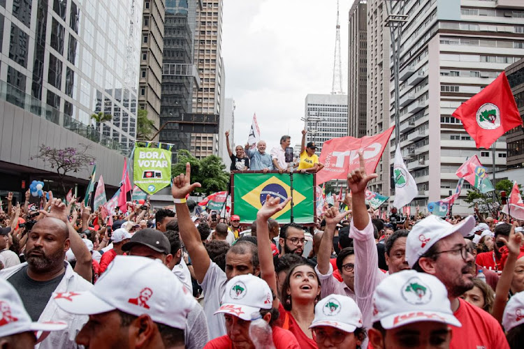 Luiz Inacio Lula da Silva, Brazil's former president (centre left) and Fernando Haddad, former mayor of Sao Paulo and gubernatorial candidate (centre right), attend a final campaign rally ahead of the runoff presidential election on Paulista Avenue in Sao Paulo, Brazil, on October 29 2022.