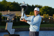 Charl Schwartzel of Stinger GC celebrates with the LIV Golf Invitational individual trophy following victory during day three of LIV Golf Invitational - London at The Centurion Club on June 11, 2022 in St Albans, England.