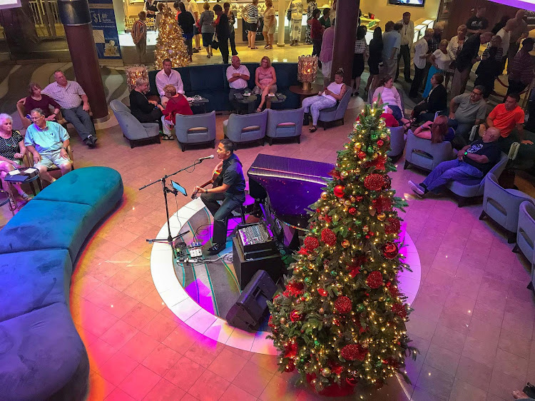 A guitarist performs during the Christmas holidays in the atrium of Norwegian Jade. 