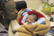 20090909AMU/NEWS. Elizabeth Mokoena ,an police official with a baby found by two members of the community in Alexandra after it was abandoned by her 30 yers old mother . PIC: ANTONIO MUCHAVE..09/09/2009. © SOWETAN