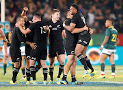 New Zealand's Beauden Barrett (C) and teammates celebrate after the Rugby Championship  match against South Africa at Loftus Versfeld in Pretoria on October 6, 2018.