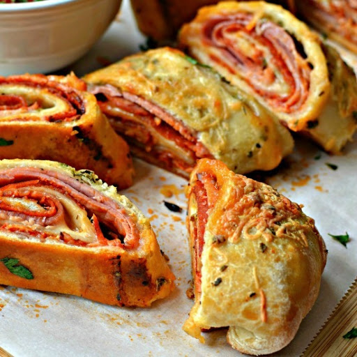 This Stromboli Recipe includes an easy made from scratch pizza dough along with helpful hints on mastering the Stromboli and making this recipe epic. This scrumptious family favorite is loaded with pepperoni, ham and mozzarella.