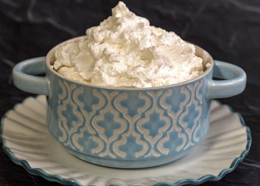 A bowl of fluffy whipped cream.