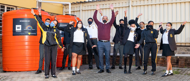 Westville Secondary School principal Adam January and his pupils celebrate getting their water tanks and hand washing stations from Woolworths and MySchool