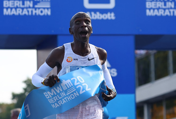 Kenya's Eliud Kipchoge celebrates as he wins the Berlin Marathon and breaks the World Record