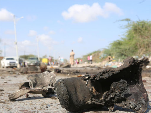 A military boot at the scene of a suicide car bomb attack by al Shabaab in Somalia's capital Mogadishu, Somalia, September 18, 2016. /REUTERS