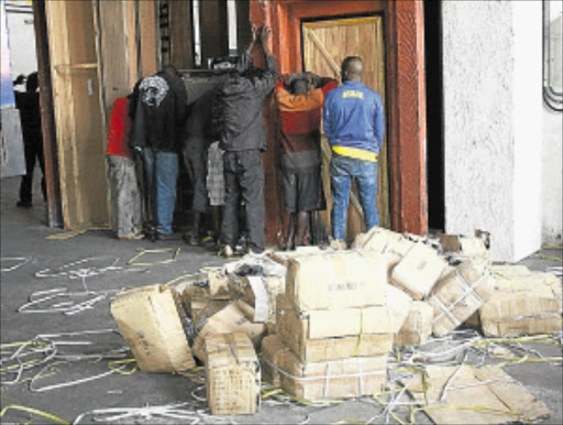 IN THE ACT: The seven suspects whom the police found off-loading stolen goods in Newtown, Johannesburg. PHOTO: SIBUSISO MSIBI