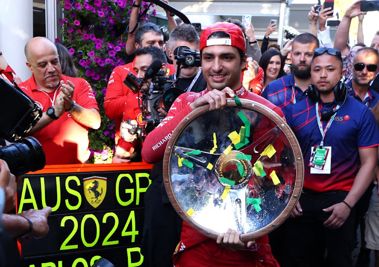 Ferrari's Carlos Sainz Jr celebrates with the trophy after winning the Australian Grand Prix. Picture: MARK PETERSON