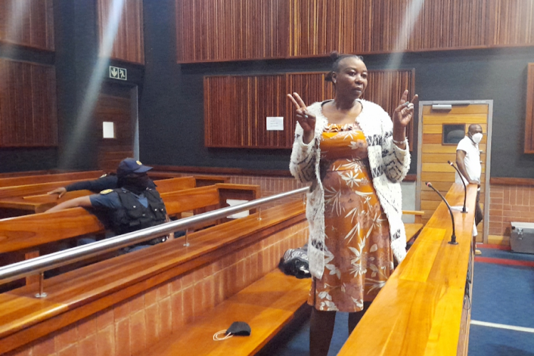 Nomia Rosemary Ndlovu poses for media in the high court in Palm Ridge before taking the stand to defend herself in a multiple murder trial.