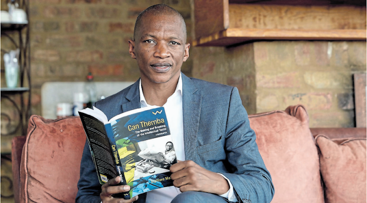 Dr Siphiwo Mahala, an author and a scholar, with his book on Can Themba.
