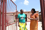 Lindi Juqu, the aunt of a previously unaccounted-for Life Esidimeni patient, chats to Gauteng health MEC Gwen Ramagopa outside the family's Soweto home on Sunday.