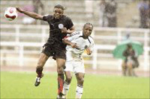 RAIN DANCE: Ajax Cape Town's Bageta Dikulu fights for the ball with Orlando Pirates' Teko Modise in their Premiership match at Johannesburg Stadium on Saturday. Pic. Antonio Muchave. 09/12/07. © Sowetan.