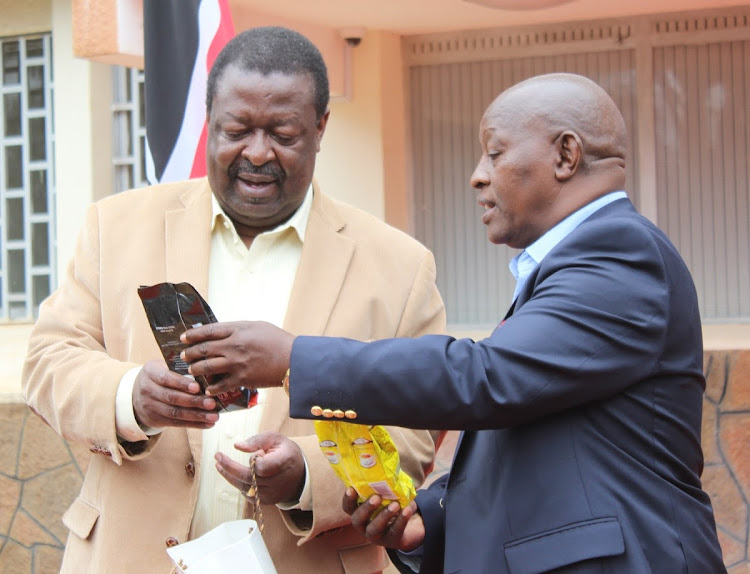 ANC party leader Musalia Mudavadi receives coffee gift from Nyeri Governor Mutahi Kahiga during his two-day visit of Nyeri. The coffee is grown, processed and packaged in Nyeri