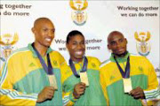 PROUD: Berlin 2009 World Championships medalists Khotso Mokoena, left, Caster Semenya and Mbulaeni Mulau8dzi pose for the media yesterday. Pic. Peggy Nkomo. 25/08/2009. © Sowetan.