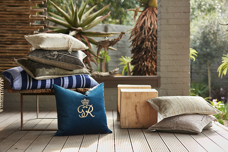 Gavin Rajah scatter cushion, R1,199, @home; oversized, blue-cotton cushion cover, R830; inner, R470, both Mungo; cotton-printed cushion, R1,050, Weylandts; X-Ray-printed cushion cover on linen, R950, Evolution Product; cotton, frayed, cream cushion cover, R448, Amatuli