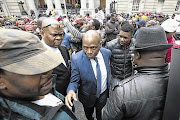 WE'VE GOT YOUR BACK: SABC chief operations officer Hlaudi Motsoeneng makes his way through a crowd of supporters outside the Cape Town High Court yesterday. The DA is making an urgent application to have him suspended from his position at the broadcaster