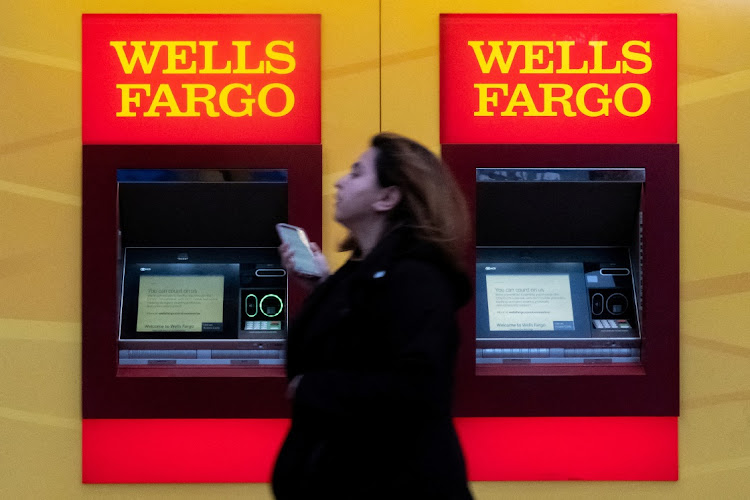 A woman walks past Wells Fargo bank in New York City, US. File photo: JEENAH MOON/REUTERS