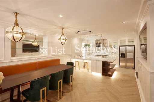 Modern kitchen with island and dining area in this luxury villa for sale in Watthana ($1,815,704 - 350 m²)