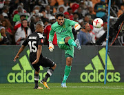 Former Cape Town City keeper  Shu-Aib Walters  clears the ball off  Orlando Pirates' Thabo Qalinge  last season.  