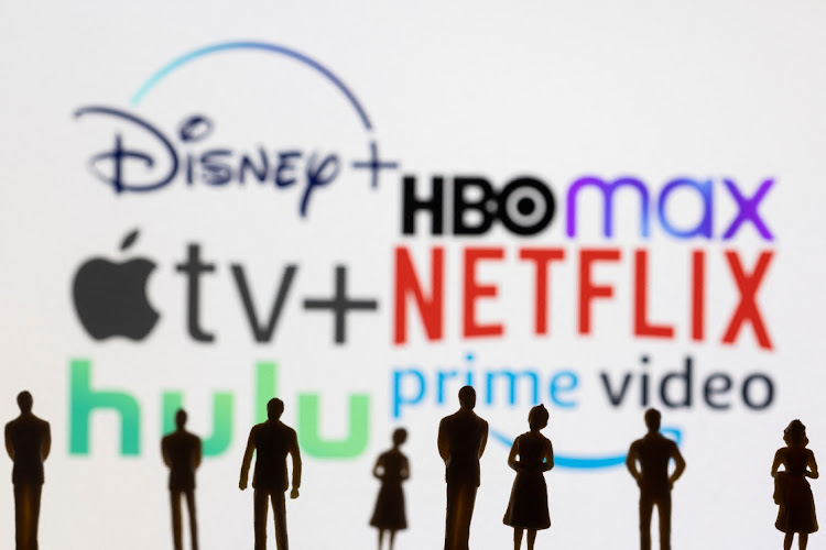 Toy figures of people are seen in front of the displayed Disney +, HBO Max, Apple TV, Netflix, Hulu and Prime video logos, in this illustration taken January 20, 2022. REUTERS/Dado Ruvic/Illustration. Picture: NETFLIX-RESULTS/DADO RUVIC