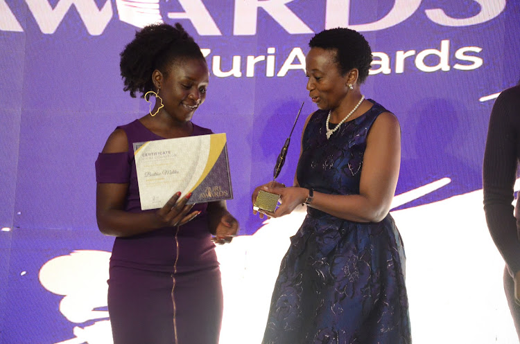 Beatrice Malaika receives the Special Category award from Kepsa chair Eva Muraya