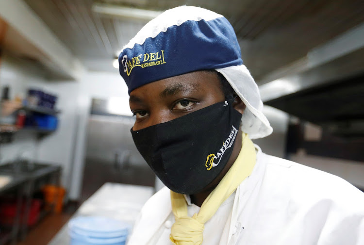 Shilla Lubia, chef of the Cafe Deli restaurant, wears a face mask while preparing food orders during the reopening after weeks of lockdown restrictions amid the coronavirus disease (COVID-19) outbreak, in Nairobi, Kenya June 11, 2020.