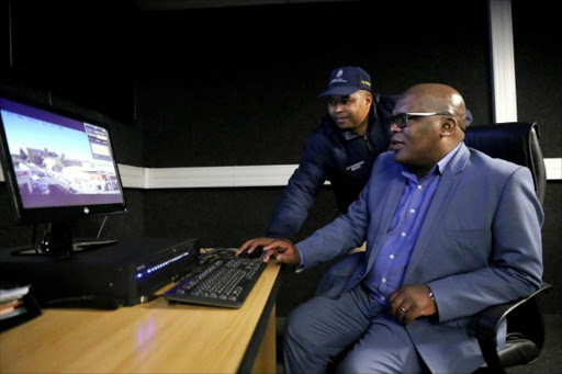 KEEPING WATCH: BCM mayor Xola Pakati with CCTV operator Thembelani Aliva at the launch of the CCTV anti-crime monitoring system yesterday Picture: SIBONGILE NGALWA