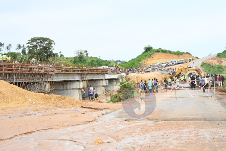 Resident looking at the section of the Mombasa Malindi highway at Mbogolo bridge that was washed away by floods on Saturday morning, November 25,2023.