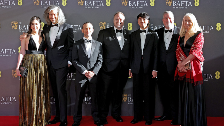 From left, a guest, Alexis Wajsbrot, Theo Bialek, Stephane Ceretti, guest, Guy Williams and guest at the 2024 EEB Bafta Film Awards at The Royal Festival Hall on February 18 2024 in London.