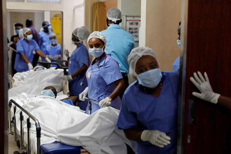 Medical staff members wait to transfer mock coronavirus patients during an exercise simulating the treatment of a large number of patients due to the spread of the coronavirus disease (COVID-19) at the Aga Khan University Hospital in Nairobi, Kenya, April 9, 2020. REUTERS/Baz Ratner