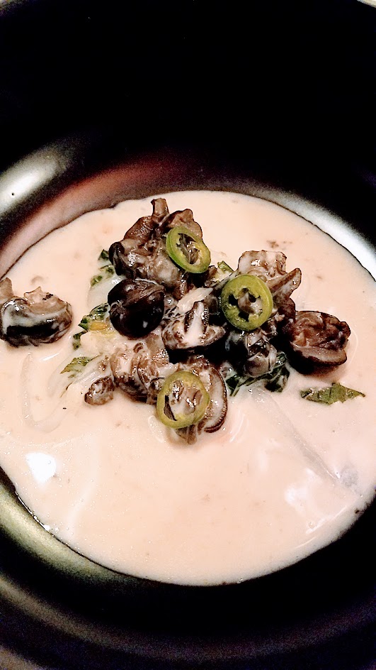 Twisted Filipino December Dinner by Carlo Lamagna Course 4: Ginataang Suso, with wild burgundy snails from his The Snail Guy friend Doug, young coconut, saluyot, serrano and coconut broth with ginger and garlic