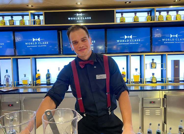 Celebrity Equinox master mixologist Daniil Razinkov prepares a series of drinks.