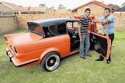 SPRUCED UP: Dillon and Duncan Fredericks with the 1962 Ford Anglia Pictures: KATHERINE MUICK-MERE