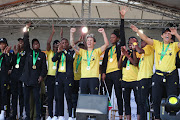 The SA national women's football team celebrate on stage after arriving home on July 26 2022.