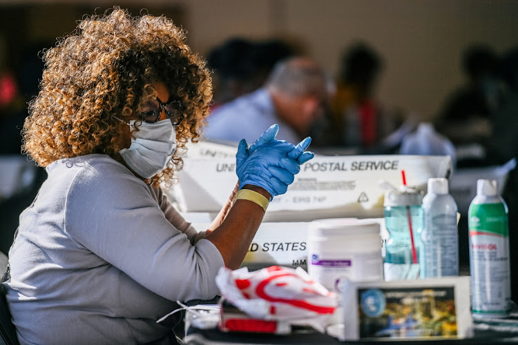 Ruby Freeman, an employee of the Fulton County Board of Registration and Elections, processes ballots in Atlanta, Georgia, U.S., on November 4, 2020.