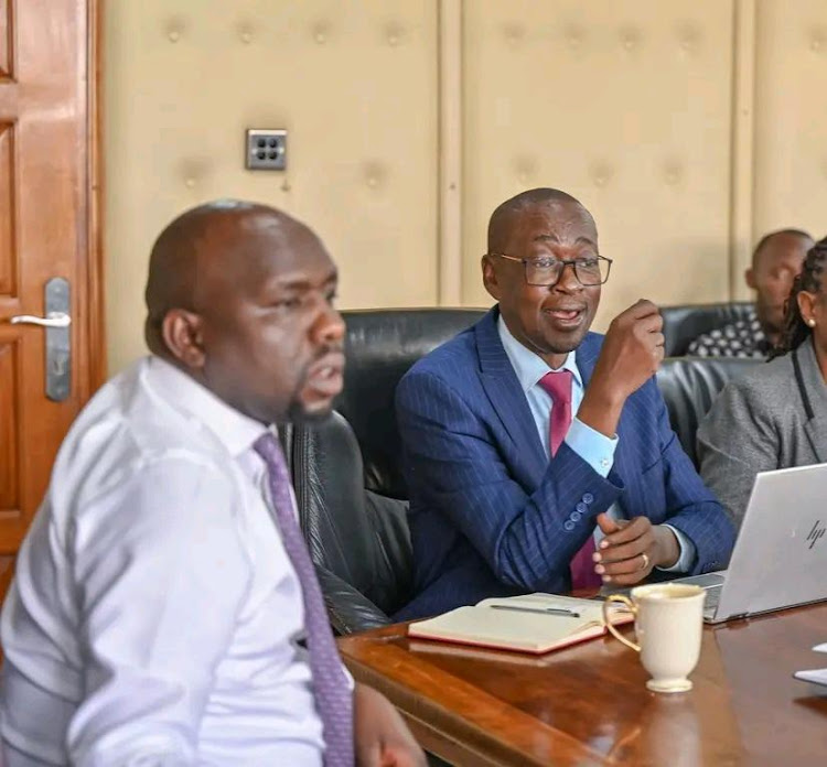 Transport Cabinet Secretary Kipchumba Murkomen (left) with late Gilbert Langat.