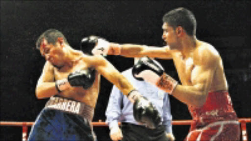 BLOOD AND CUTS: Britain's Amir Khan, right, in action against Mexico's Marco Antonio Barrera during a WBA International Lightweight Championship boxing fight at the MEN in Manchester, England, on Saturday March 14, 2009. (AP Photo/PA, Peter Byrne) ** UNITED KINGDOM OUT, NO SALES, NO ARCHIVE **