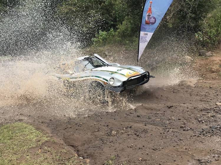 Geoff Bell from South Africa powers his Datsun through a river crossing section in a past event