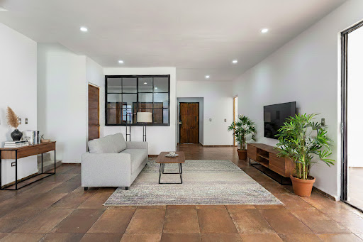 Modern living room with grey sofa and TV stand - Prestige property for sale in San Miguel de Allende, 4 bedrooms